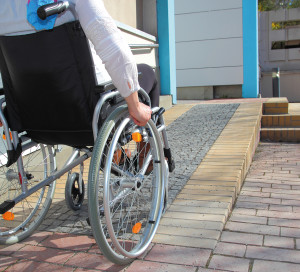 Woman in a wheelchair using a ramp